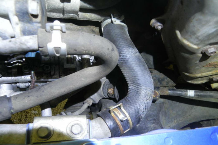 Photo of radiator hose replacement to repair cooling system problem.